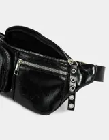 Riñonera negra de cuerina con múltiples bolsillos con cierre y correa ajustable con hebilla metálica.