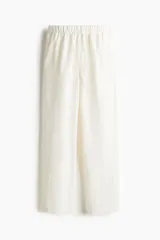Pantalón tobillero de corte holgado en tejido liviano de mezcla de lino. Modelo de tiro alto con elástico revestido y cordón para ajustar fino en la cintura, bolsillos al bies y piernas ajustadas.