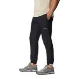 Pantalón deportivo negro de corte ajustado, con cintura elástica ajustable, bolsillos laterales con cierre y puños elásticos.