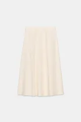 Falda midi color crema de tiro alto, confeccionada en hilatura con lino. Presenta bolsillos laterales ocultos en costura y cierre frontal con botones.