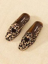 Mocasín mule de cuero con estampado animal print, capellada con recorte decorativo y aplique de corazón.