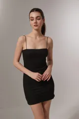 Vestido negro ajustado de tirantes finos, con escote cuadrado.
