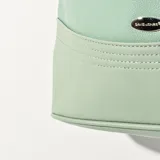 Cartera tipo hobo color verde agua, con doble asa de hombro, cierre superior y detalle de borla colgante.