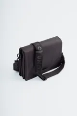 Bandolera negra con correa ancha de tela con la marca Rotunda estampada.