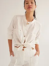 Camisa color marrón de lino y viscosa, de corte clásico, con cuello camisero, cierre frontal con botones, mangas largas con puños abotonados y dos bolsillos de parche en el pecho.