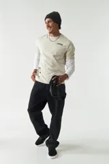 Remera de manga corta color ladrillo, con cuello redondo y estampado con texto y diseño abstracto en el frente.