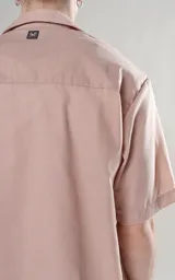 Camisa color beige de manga corta con calce oversize y canesú en la espalda.