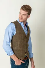 Chaleco de tweed marrón con diseño a cuadros, cierre frontal con botones dorados y dos bolsillos delanteros.
