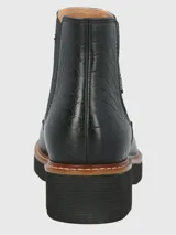 Botín Chelsea de cuero negro, estilo botín corto, con elásticos laterales y suela plataforma gruesa de goma con borde de cuero marrón y costura visible.