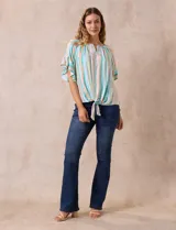 Blusa estampada de rayas verticales en tonos verde, celeste, amarillo y naranja, con cuello cuadrado, escote en V con aplique metálico y bordado con brillos. Tiene mangas cortas amplias y terminación con nudo en el ruedo.