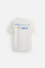 Camiseta blanca de corte recto, cuello redondo y manga corta. Estampado pequeño en el pecho con texto en rojo.