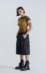 Pantalón negro con corte ancho, bolsillos laterales con solapa y detalle de cierre a la altura de la rodilla para convertirlo en short.