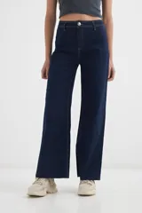 Pantalón jean azul oscuro de corte wide leg, con tiro alto y costuras a la vista.