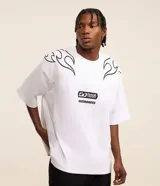 Remera blanca de corte oversized, confeccionada en tejido de malla de algodón. Presenta cuello redondo, mangas cortas y estampados con lettering y motivos maoríes en color negro.
