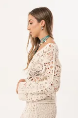 Saco color crudo de crochet con botones y mangas largas.