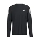 Remera deportiva de manga larga Adidas Own The Run, color negro con logo blanco en el pecho y tres tiras blancas en los hombros.