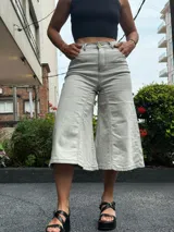 Pantalón capri gris de tiro alto, pierna ancha y largo midi.