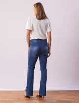 Jean bootcut de tiro alto marca Harmony & Havoc, con terminación de pierna acampanada, pretina con pasadores, botón y cierre. Delantera con bolsillos inclinados, trasera con bolsillos aplicados.