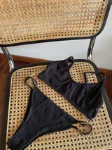 Top de bikini negro con breteles finos ajustables.