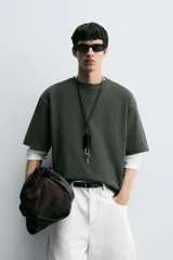 Remera verde oscuro de corte oversize, manga corta y cuello redondo.