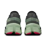 Championes de running On Cloudmonster 2, color negro con detalles en verde y rosa.
