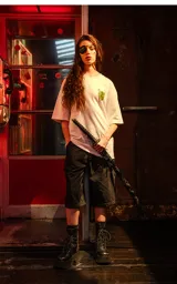 Remera blanca de corte holgado con un pequeño estampado amarillo en el pecho, inspirado en la película Kill Bill.