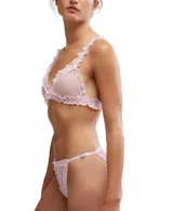 Conjunto de ropa interior Free People color verde esmeralda, compuesto por un top corto de punto canalé con ribete de encaje en los tirantes y una tanga transparente con lunares y ribete de encaje. Elástico ajustable en los laterales.