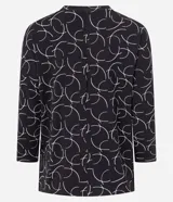 Blusa de mangas 7/8 confeccionada en viscosa sostenible, con cuello redondo y estampado de semicírculos blancos sobre fondo negro.