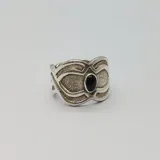 Anillo de plata 925 con diseño texturizado y piedra negra circular engarzada.