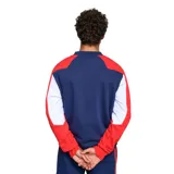 Buzo deportivo blanco, con mangas azul marino y detalles en rojo en los hombros. Presenta el logo de Umbro bordado en el pecho y el escudo del Club Nacional de Football.