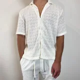 Camisa de tejido calado color blanco, con cuello tipo cubano, manga corta y cierre frontal con botones.