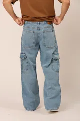 Pantalón de jean celeste, corte holgado, con bolsillos cargo laterales y costuras frontales.