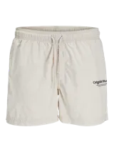 Short de baño color beige con cintura elástica ajustable con cordón, bolsillos laterales y logo de Originals Studio estampado en la pierna.