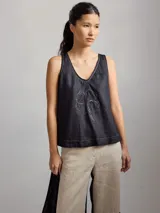 Musculosa negra de lino con escote en V y bordado de un trébol de cuatro hojas en el centro.