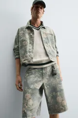 Bermuda de algodón celeste con estampado floral, corte relaxed fit, cinco bolsillos, tira y bolsillo multifunción en la pierna, cierre frontal con cremallera y botón.