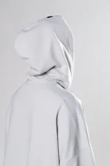 Hoodie corto color gris claro, de corte holgado, con capucha y cordones negros.