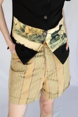 Short unisex color verde con rayas verticales, tiro alto, pinzas y bolsillos.