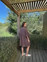 Vestido camisero azul de lino italiano, con cuello camisero, botones frontales, mangas 3/4 con doble volado y bolsillos laterales.