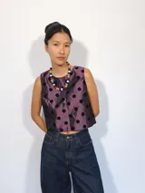 Remera corta de tafeta color verde militar con lunares de terciopelo negros, corte a la base y botón en la parte trasera.