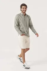 Camisa de lino color blanco, de corte regular, con cuello clásico y mangas largas.