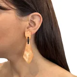 Caravanas de resina en tono salmón y negro, de diseño moderno y ligero, con un largo de 6 cm.