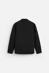 Camisa color crema de corte regular fit, confeccionada en tejido con viscosa. Tiene cuello solapa, manga larga con puños abotonados, bolsillo de parche en el pecho y cierre frontal con botones.