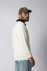 Sweater de punto verde con cuello polo color crema y bordado frontal con texto en blanco.