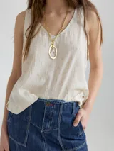 Musculosa color crudo con textura, de corte holgado y relajado.