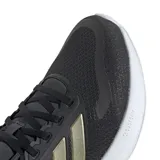 Championes Adidas Runfalcon 5, color negro con detalles dorados y suela blanca. Zapatillas de running con tecnología Cloudfoam para mayor amortiguación y comodidad.