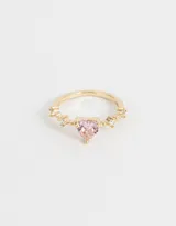 Anillo dorado con dije de corazón rosa y strass blancos.