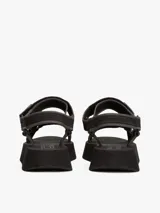 Sandalias de plataforma negras con suela dentada gruesa. Presentan tiras de tejido trenzado ajustables con velcro y un parche tonal con el logo de Tommy Jeans.