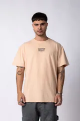 Remera color durazno de algodón lavado con estampa frontal con la frase "Coffee Break is the best kind of break".