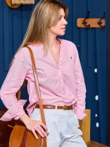 Camisa de manga larga a rayas verticales rosas y blancas, sin cuello y con dos botones.