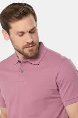 Remera polo azul de piqué liso, con cuello de rib y botones personalizados.